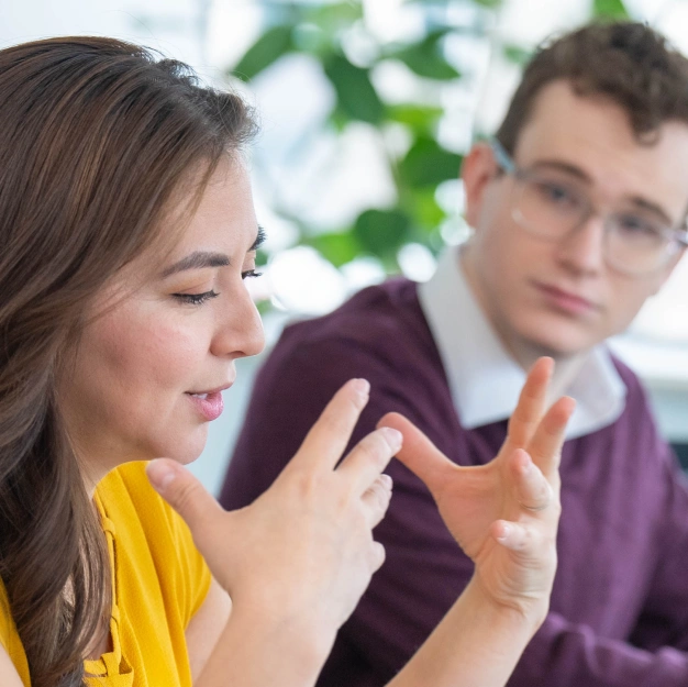 Two people discussing DentalQore's strategic approach to digital marketing