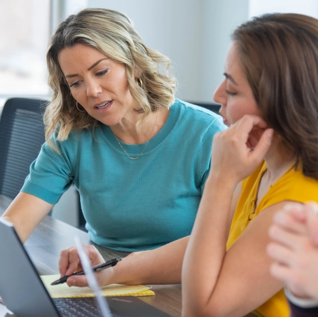 Two people discussing DentalQore's different packages